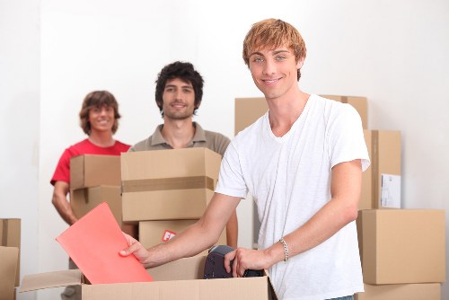 Moving crew handling packed boxes during a removal van service