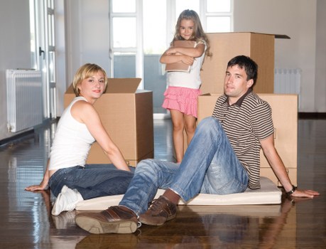 Local moving team handling boxes in a Westminster property with limited access